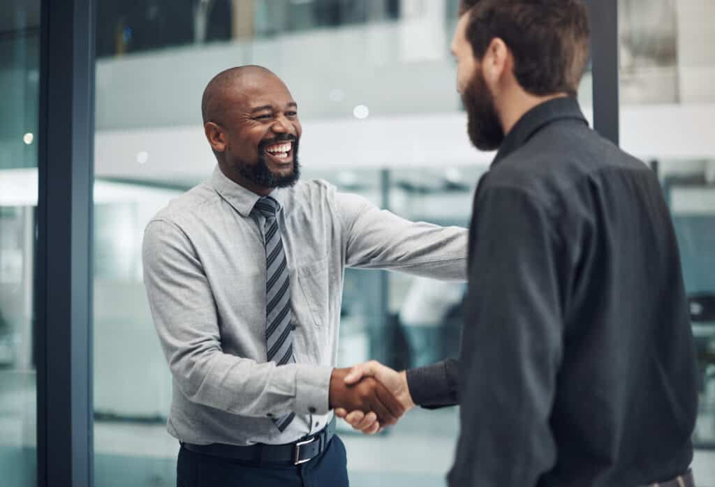 Shot of a mature businessman shaking hands with a colleague in a modern office stock photo