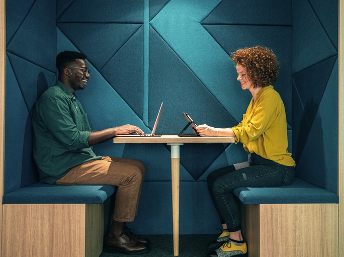 Young business people working in modern co-working space office using digital devices